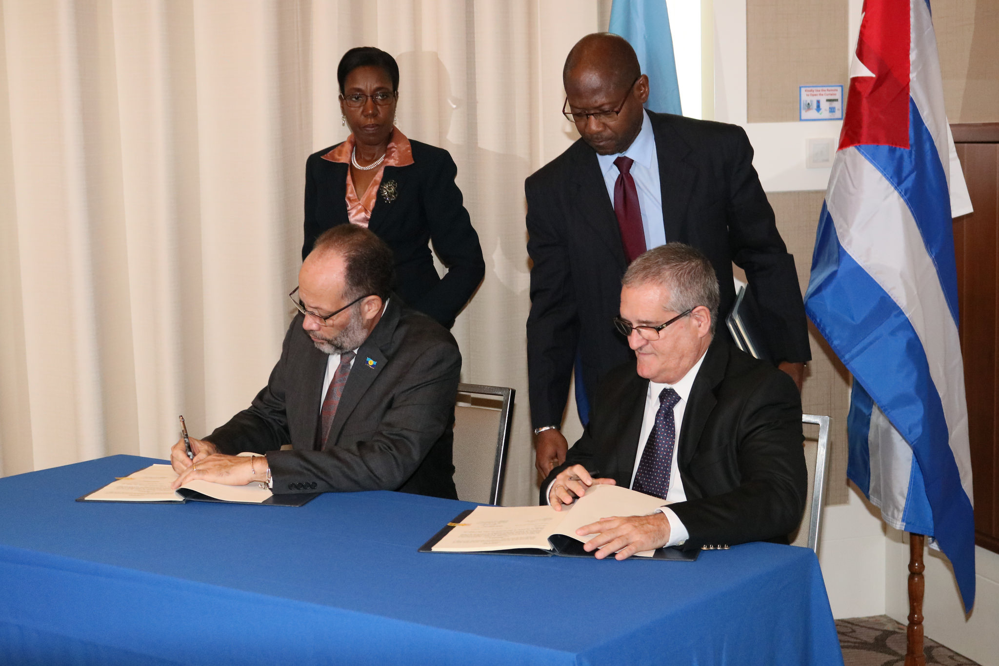 CARICOM Secretary-General, Amb. Irwin LaRocque and Cuban Ambassador to CARICOM, His Excellency, Julio Cesar Gonzalez Marchante sign the Agreement