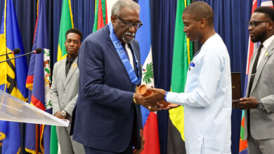 Photo of Sir Clive Lloyd and Roderick Rainford conferred with OCC at 47th HGC Opening Ceremony