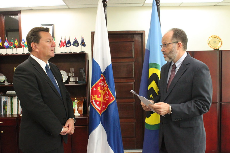 Ambassador Irwin LaRocque, CARICOM Secretary-General, delivers brief remarks as Plenipotentiary Representative of Finland to CARICOM, His Excellency Jukka Pietikӓinen, pays keen attention.